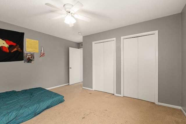 402 Teakwood Dr, Victoria, TX 77901 - carpeted bedroom with multiple closets, baseboards, and ceiling fan