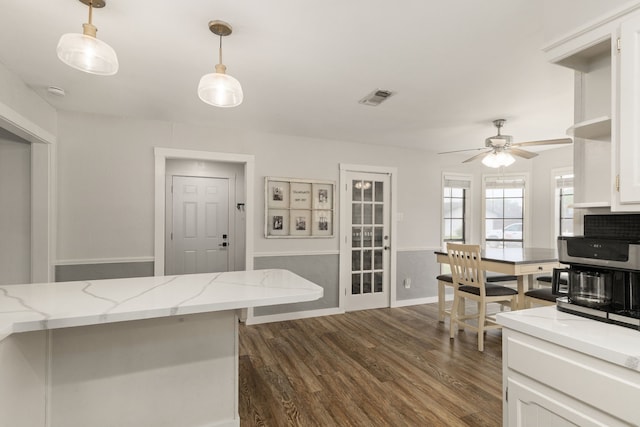 402 Teakwood Dr, Victoria, TX 77901 - kitchen featuring dark wood-type flooring, a ceiling fan, white cabinetry, and decorative light fixtures
