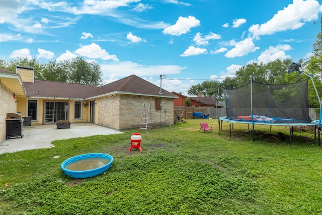 402 Teakwood Dr, Victoria, TX 77901 - view of yard featuring a trampoline and a patio