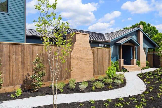 703 E 9th St, Houston, TX 77007 - view of front of property with a standing seam roof, metal roof, and a chimney