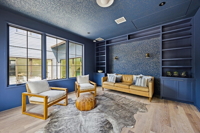 703 E 9th St, Houston, TX 77007 - sitting room featuring wood finished floors, built in shelves, and baseboards