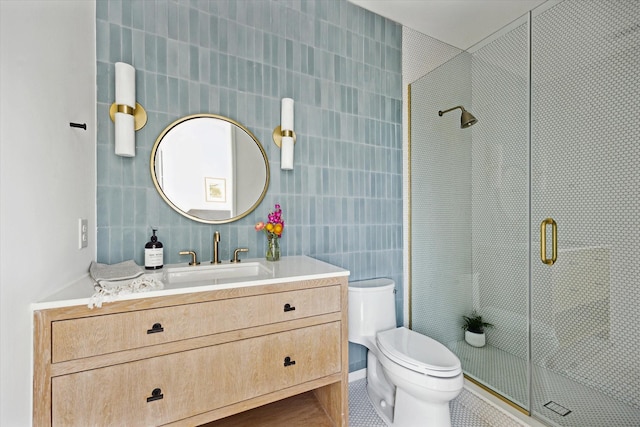 703 E 9th St, Houston, TX 77007 - bathroom with a shower stall, vanity, toilet, tile walls, and tile patterned flooring