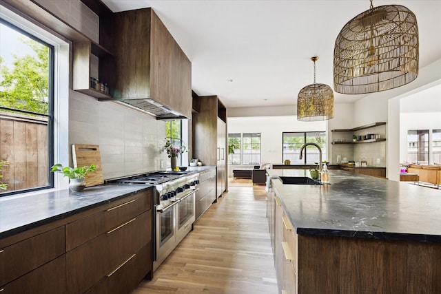 703 E 9th St, Houston, TX 77007 - kitchen featuring range with two ovens, open shelves, modern cabinets, a sink, and light wood-style flooring