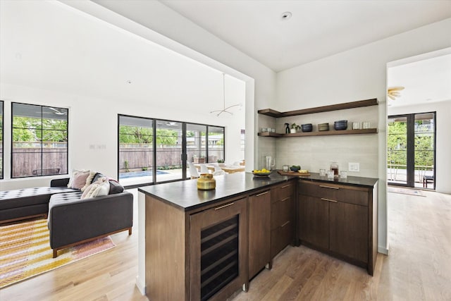 703 E 9th St, Houston, TX 77007 - kitchen with dark countertops, healthy amount of natural light, light wood finished floors, and open shelves