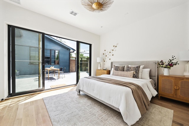 703 E 9th St, Houston, TX 77007 - bedroom featuring access to exterior and wood finished floors