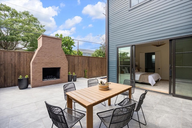 703 E 9th St, Houston, TX 77007 - fenced backyard with exterior fireplace, a patio, and outdoor dining area