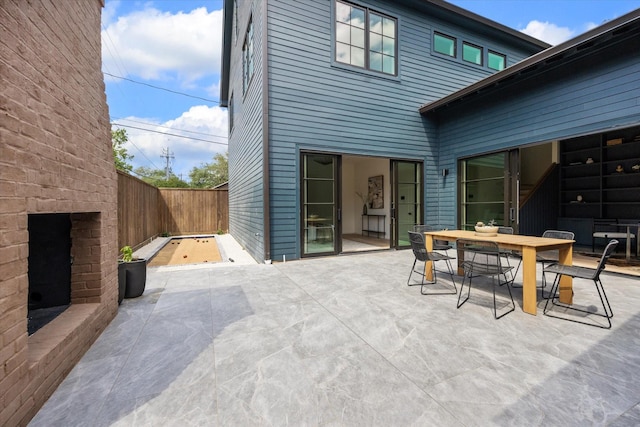 703 E 9th St, Houston, TX 77007 - view of patio with outdoor dining space and an outdoor brick fireplace