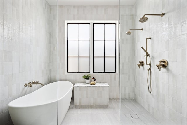 703 E 9th St, Houston, TX 77007 - full bathroom featuring a walk in shower, a freestanding bath, tile walls, and tile patterned flooring