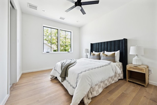 703 E 9th St, Houston, TX 77007 - bedroom with light wood-type flooring, baseboards, and ceiling fan