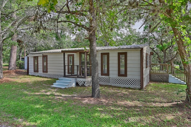 11200 Leisure Rd, Brenham, TX 77833 - back of property featuring metal roof and a yard