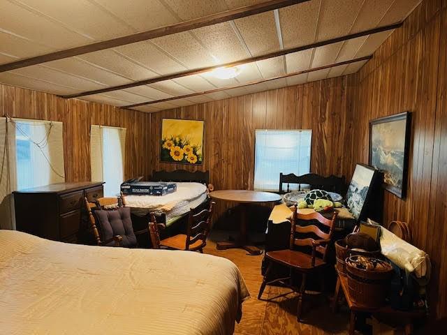 11200 Leisure Rd, Brenham, TX 77833 - bedroom with wood walls and wood finished floors