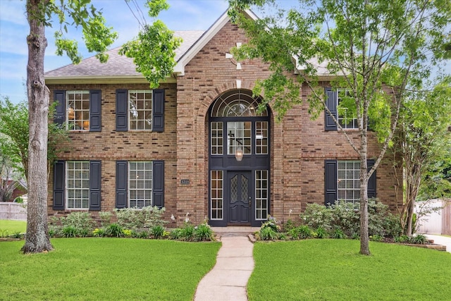 1318 N Gabriel River Cir, Sugar Land, TX 77478 - view of front of house featuring brick siding, a front yard, and a shingled roof
