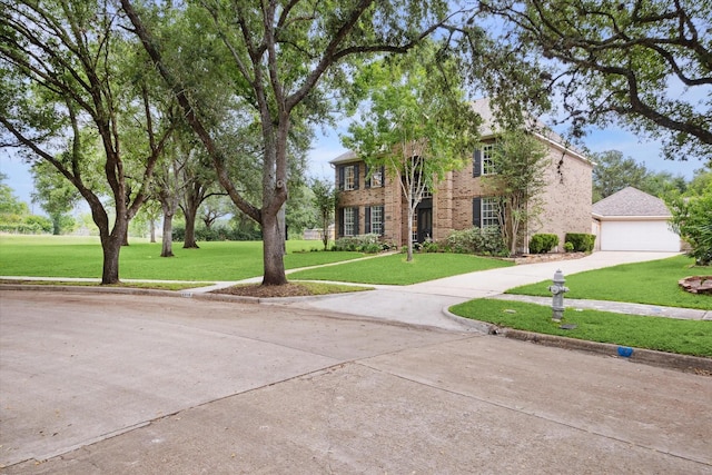 1318 N Gabriel River Cir, Sugar Land, TX 77478 - view of front of house featuring concrete driveway, a front yard, a garage, and brick siding