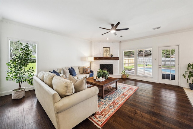 1318 N Gabriel River Cir, Sugar Land, TX 77478 - living area with a ceiling fan, plenty of natural light, crown molding, wood-type flooring, and a brick fireplace