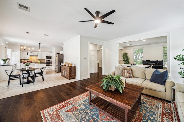 1318 N Gabriel River Cir, Sugar Land, TX 77478 - living area featuring ceiling fan, crown molding, light wood finished floors, and a chandelier