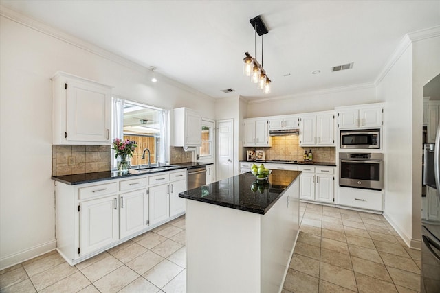 1318 N Gabriel River Cir, Sugar Land, TX 77478 - kitchen featuring appliances with stainless steel finishes, a sink, ornamental molding, decorative backsplash, and a center island