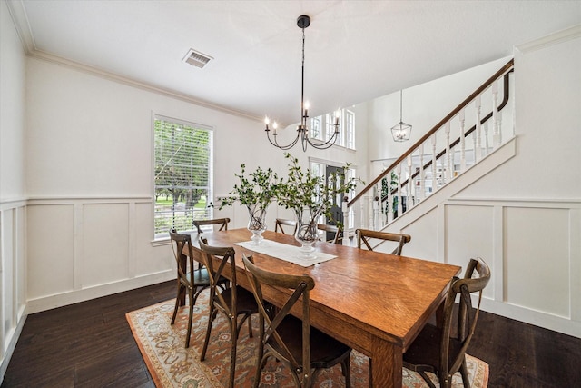 1318 N Gabriel River Cir, Sugar Land, TX 77478 - dining room with a decorative wall, crown molding, dark wood finished floors, a chandelier, and stairway