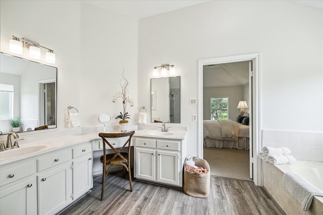 1318 N Gabriel River Cir, Sugar Land, TX 77478 - ensuite bathroom featuring double vanity, wood finished floors, and a garden tub
