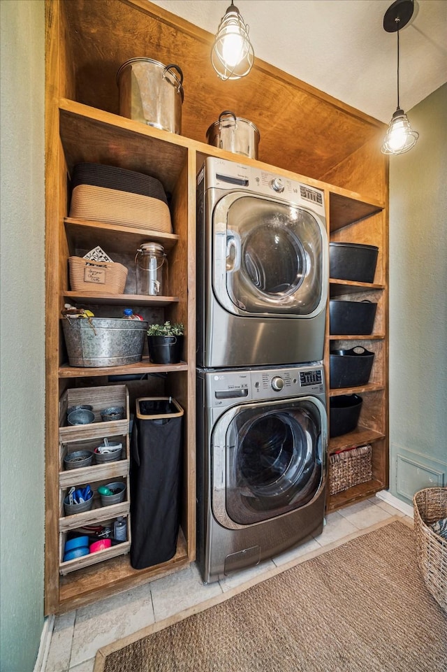 1318 N Gabriel River Cir, Sugar Land, TX 77478 - laundry room with stacked washer / dryer, tile patterned floors, and baseboards