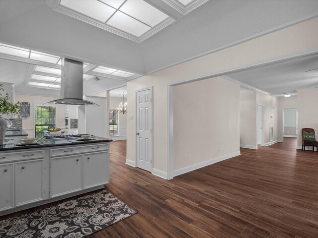 1400 Oak Hollow Dr, Dickinson, TX 77539 - kitchen with island range hood, dark countertops, dark wood-type flooring, open floor plan, and a chandelier