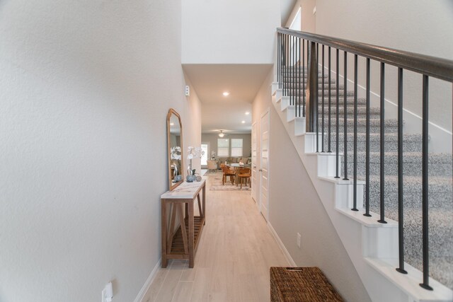 17542 Rosette Grass Dr, Conroe, TX 77385 - hall with stairs, baseboards, wood finished floors, and recessed lighting