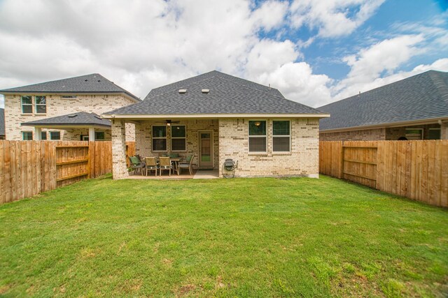 17542 Rosette Grass Dr, Conroe, TX 77385 - back of property with ceiling fan, brick siding, a patio, and a shingled roof