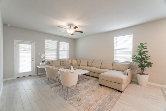17542 Rosette Grass Dr, Conroe, TX 77385 - living room featuring wood finished floors, ceiling fan, and baseboards