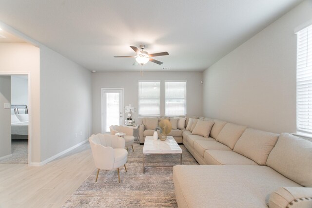 17542 Rosette Grass Dr, Conroe, TX 77385 - living area with light wood finished floors, ceiling fan, and baseboards