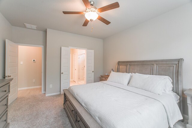 17542 Rosette Grass Dr, Conroe, TX 77385 - bedroom featuring light carpet, connected bathroom, ceiling fan, and baseboards