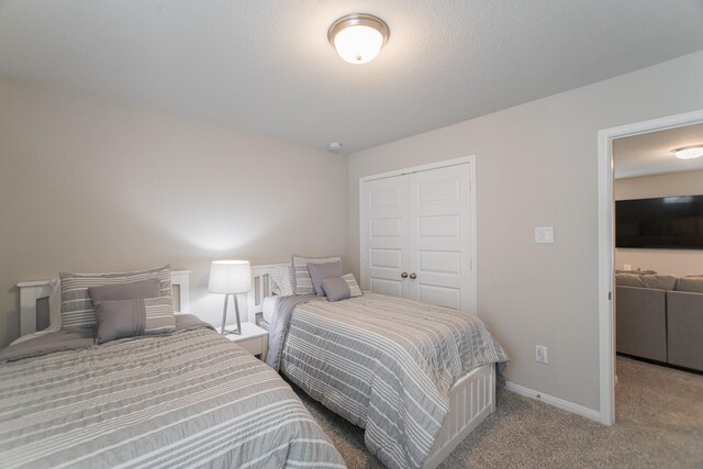 17542 Rosette Grass Dr, Conroe, TX 77385 - bedroom with a closet, carpet, and baseboards