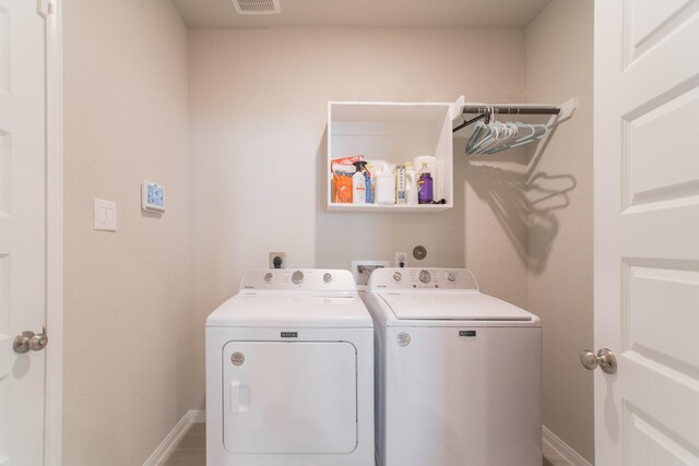 17542 Rosette Grass Dr, Conroe, TX 77385 - washroom featuring separate washer and dryer and baseboards