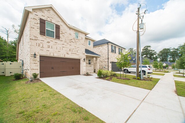 17542 Rosette Grass Dr, Conroe, TX 77385 - view of front of home featuring a garage, brick siding, and driveway