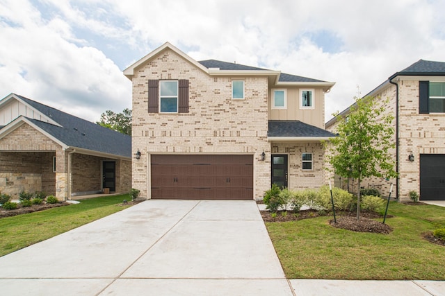 17542 Rosette Grass Dr, Conroe, TX 77385 - view of front of home featuring board and batten siding, an attached garage, concrete driveway, brick siding, and a front yard