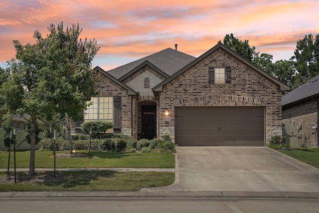 10029 Red Beadtree Pl, Conroe, TX 77385 - french provincial home with brick siding, driveway, a lawn, stone siding, and a shingled roof