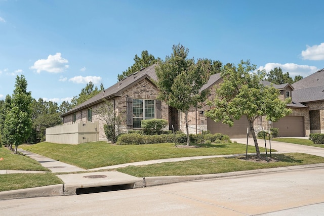 10029 Red Beadtree Pl, Conroe, TX 77385 - view of front of property with brick siding, concrete driveway, a front lawn, an attached garage, and a shingled roof
