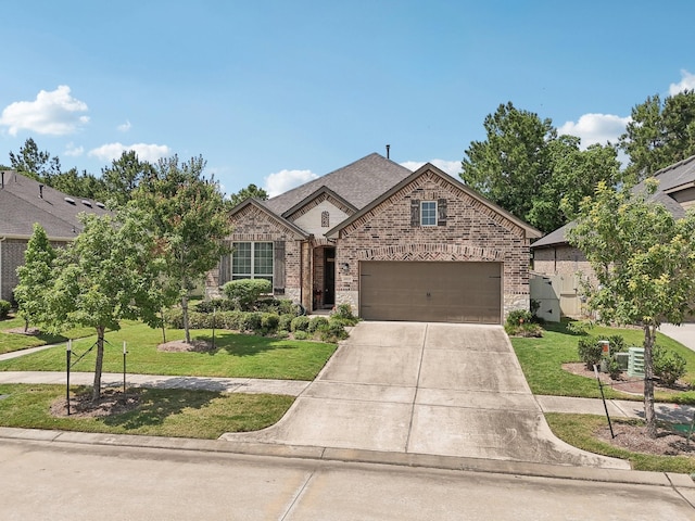 10029 Red Beadtree Pl, Conroe, TX 77385 - view of front of home with driveway, brick siding, an attached garage, and a front lawn
