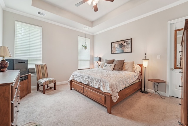 10029 Red Beadtree Pl, Conroe, TX 77385 - bedroom featuring light carpet, a tray ceiling, baseboards, a ceiling fan, and crown molding