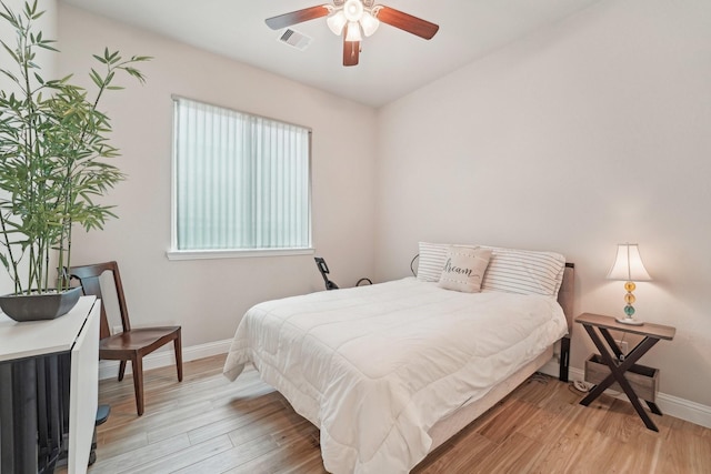 10029 Red Beadtree Pl, Conroe, TX 77385 - bedroom with baseboards and light wood finished floors