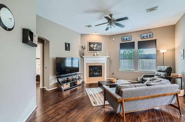 2604 Hewn Rock Way, Pearland, TX 77584 - living room with ceiling fan, hardwood / wood-style flooring, a tiled fireplace, arched walkways, and baseboards