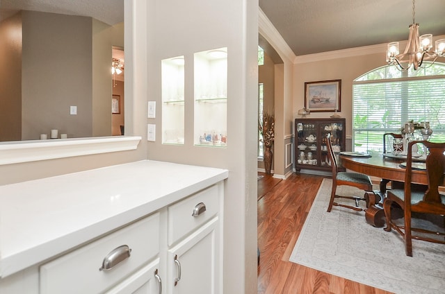 24511 Pelican Hill Dr, Katy, TX 77494 - dining space with light wood-type flooring, ornamental molding, and a chandelier