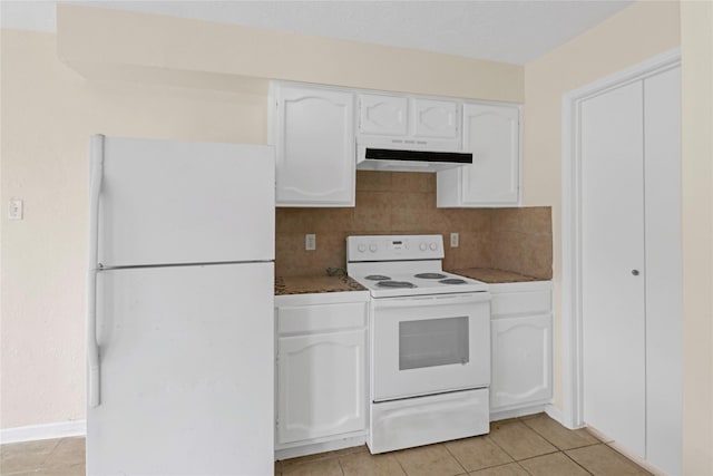 10211 Golden Meadow Dr, Houston, TX 77064 - kitchen featuring white appliances, under cabinet range hood, white cabinets, and light tile patterned floors
