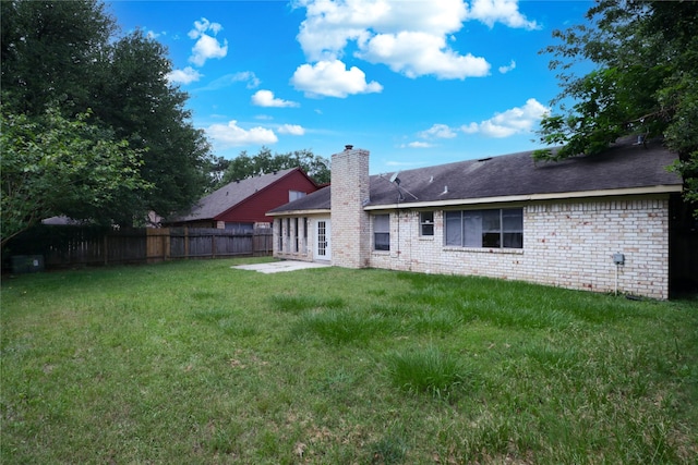 10211 Golden Meadow Dr, Houston, TX 77064 - back of house with a chimney, a patio area, and brick siding
