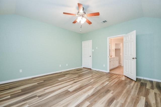 21126 N Yellow Bud Ct, Cypress, TX 77433 - unfurnished bedroom featuring vaulted ceiling, light wood-style floors, ensuite bath, baseboards, and a ceiling fan