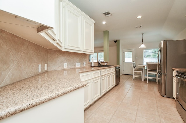 21126 N Yellow Bud Ct, Cypress, TX 77433 - kitchen featuring a sink, stainless steel appliances, backsplash, light tile patterned floors, and white cabinets