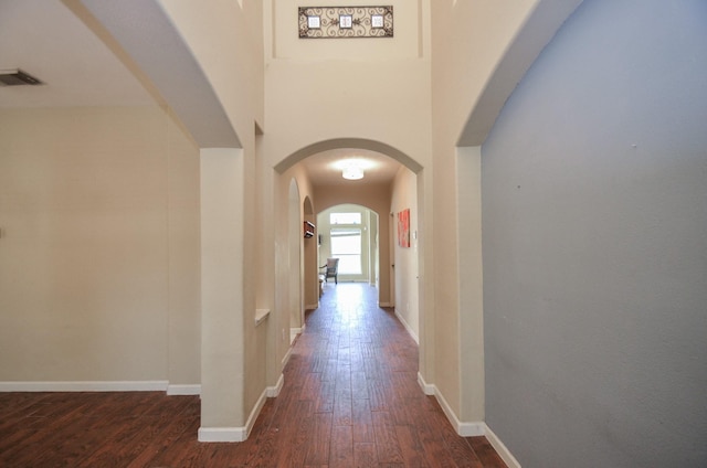 17719 Creek Bluff Ln, Cypress, TX 77433 - hall featuring dark wood-style flooring, arched walkways, and baseboards