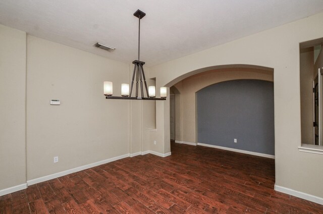 17719 Creek Bluff Ln, Cypress, TX 77433 - empty room featuring wood finished floors, a chandelier, baseboards, and arched walkways