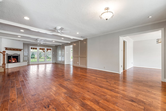 1907 Round Lake Dr, Houston, TX 77077 - unfurnished living room with a ceiling fan, dark wood finished floors, a textured ceiling, a fireplace, and baseboards