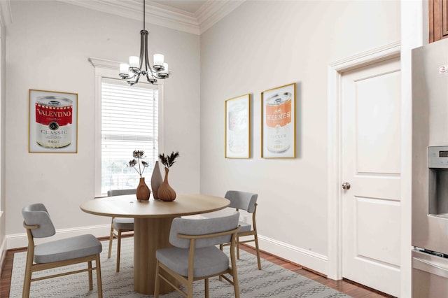2510 Travis St Unit 301, Houston, TX 77006 - dining room featuring a chandelier, wood finished floors, ornamental molding, healthy amount of natural light, and baseboards