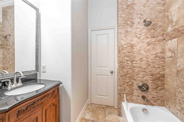 2510 Travis St Unit 301, Houston, TX 77006 - bathroom featuring vanity,  shower combination, baseboards, and stone finish flooring