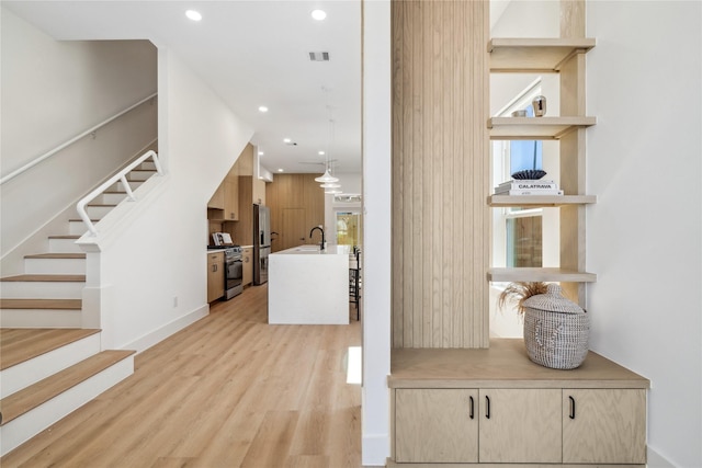 612 Hughes St, Houston, TX 77023 - stairs featuring wood finished floors and recessed lighting